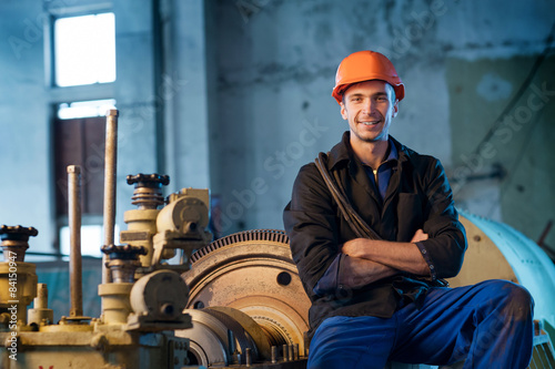 Portrait worker in helmet near the turbine. Work the factory Poster