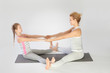Mother and daughter doing yoga exercise