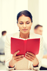 Poster - woman reading book in college or office