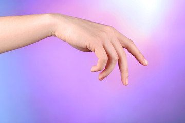 Wall Mural - Female hand on colorful background