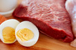 close up of red meat fillets and boiled eggs