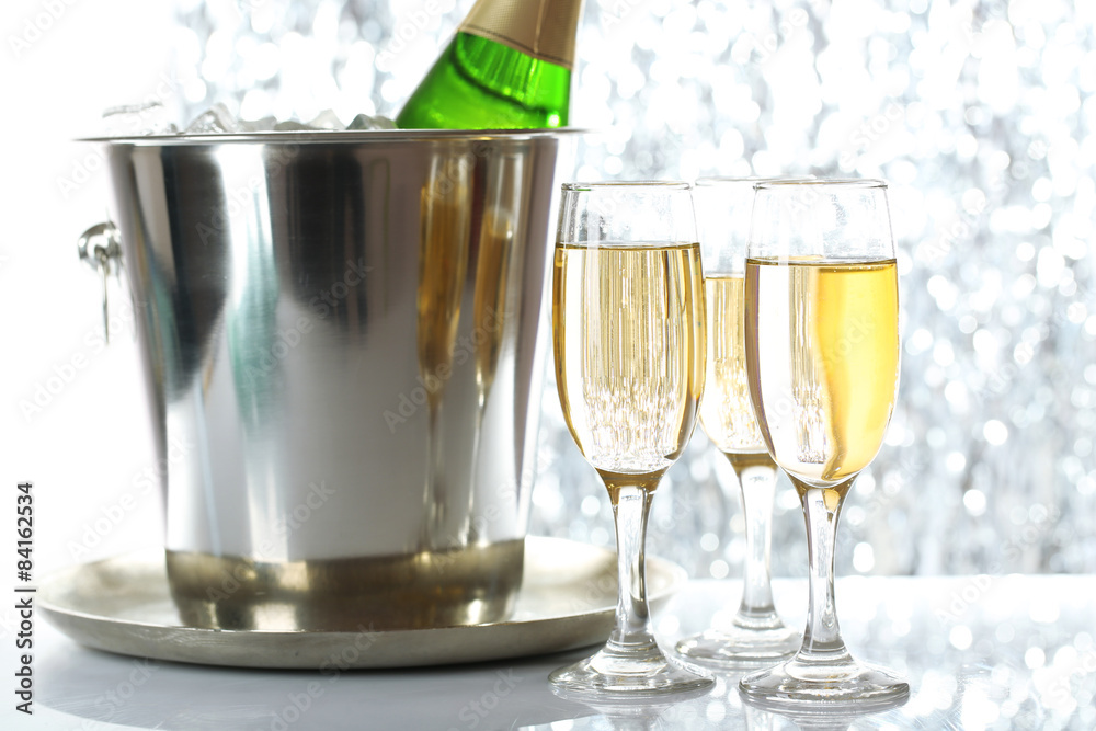Glasses of champagne on bright background