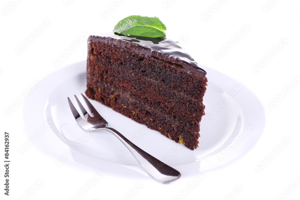Piece of chocolate cake with mint isolated on white