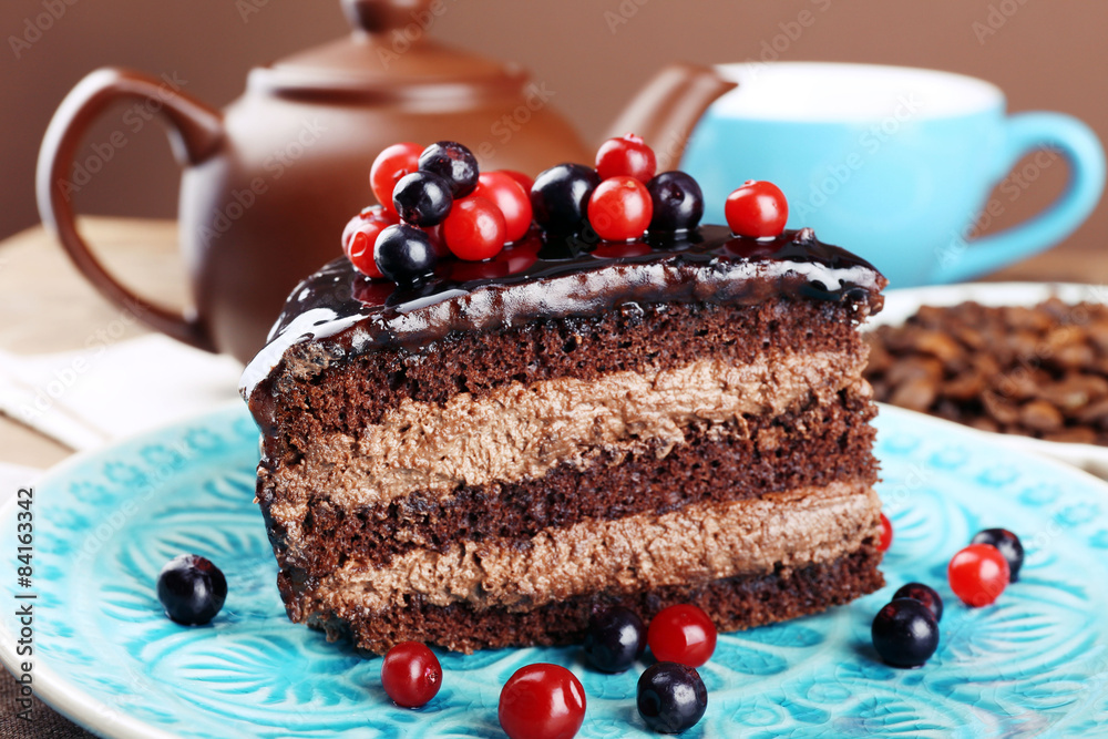 Delicious chocolate cake with berries on plate on table close up
