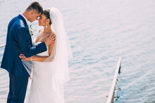  Portrait Of Happy Bride And Groom Posing On Pier At Lake
