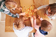 © Monkey Business - Children sharing a pizza together, overhead view
