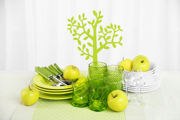 Wall Mural - Colorful table settings and tulip flowers in vase on table, on light background