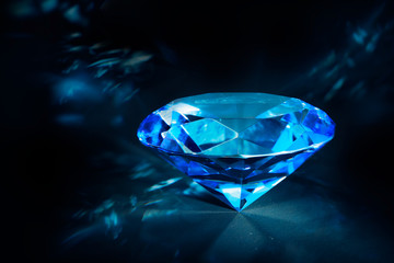 Wall Mural - Shiny blue Diamond on a black background