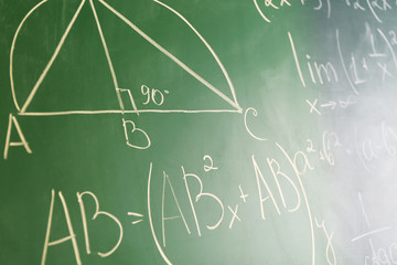 Mathematics formulas on blackboard background