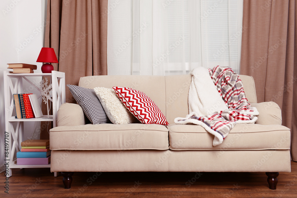 Sofa with colorful pillows in room