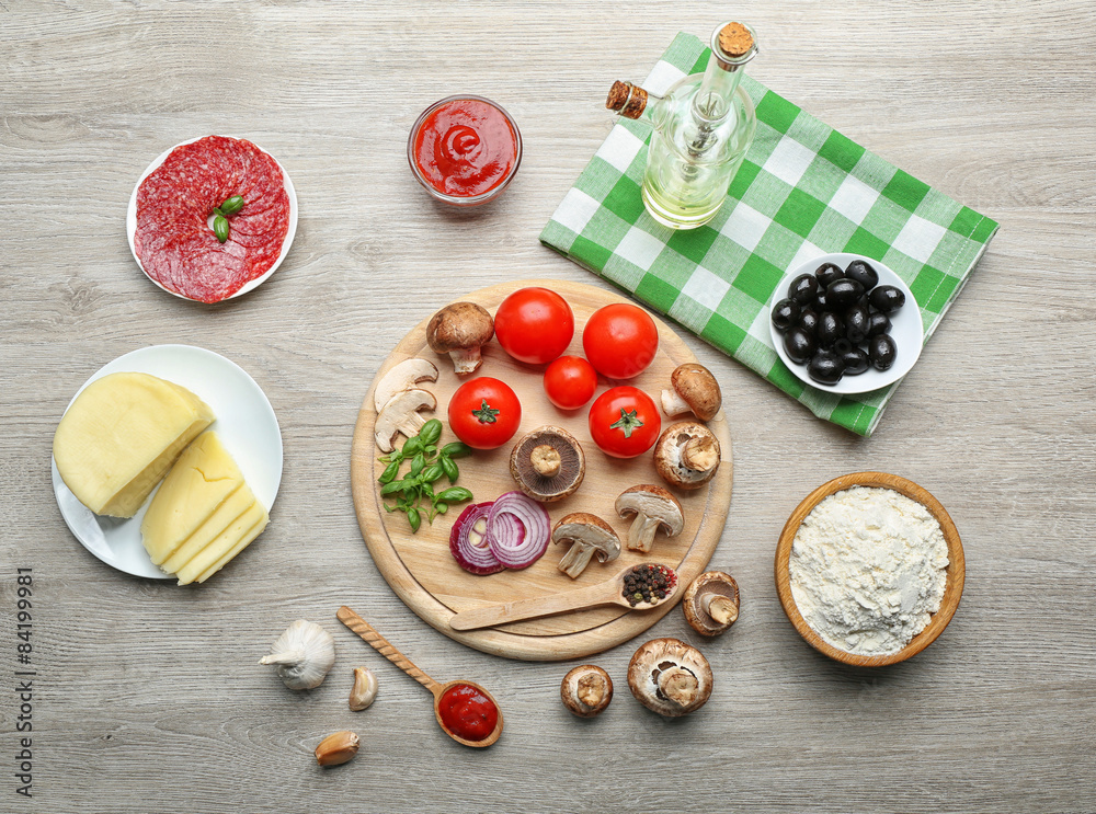 Ingredients for cooking pizza on wooden table, top view