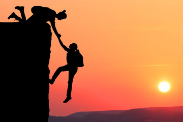 Teamwork couple hiking help each other trust assistance silhouette 