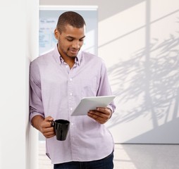 Poster - Casual afro american office worker reading tablet