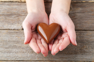 Woman's hands with chocolate heart