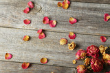 Fototapeta Tulipany - Dried roses on grey wooden background