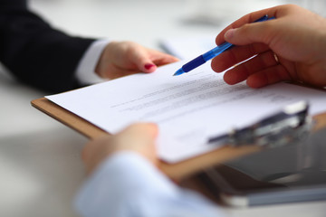 Businesspeople sitting on the desk on office