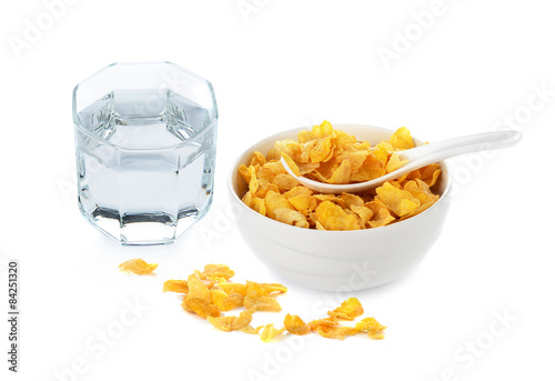 cornflakes in white bowl and drinking water on white