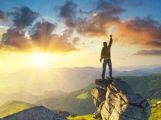 Wall Mural - silhouette of a champion on mountain peak. active life concept