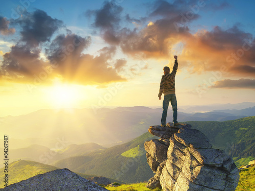 Cuadros en Lienzo Silhouette of a champion on mountain peak. Active life concept