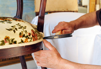 Upholsterer lining the seat of a chair