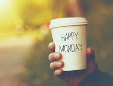 Hand Holding Paper Cup Of Coffee With Happy Monday Motivational