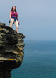Female hiker on cliff edge near Tintagel Cornwall