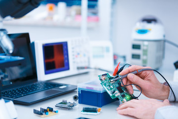 Wall Mural - Using the microscope electronics laboratory