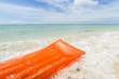 orange air mattress in the sea