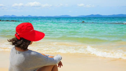 Lonely girl sitting on the beach