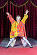 Girl Clown Standing with Open Arms on Stage