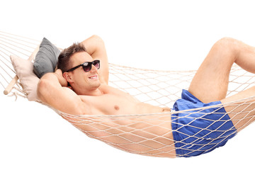 Canvas Print - Relaxed young guy lying in a hammock