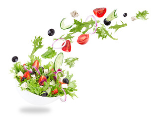 Fresh salad with flying vegetables ingredients