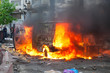 Burning car in the center of city during unrest