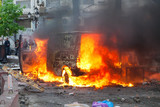 Fototapeta  - Burning car in the center of city during unrest
