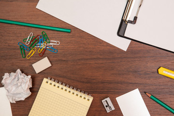 office supplies scattered on wood background