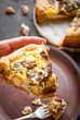 © somegirl - Woman's hand holding a caramelized garlic tart with goat cheese