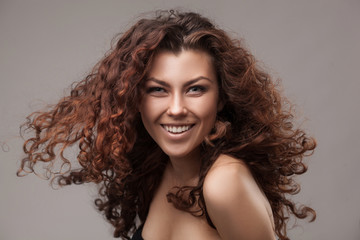 smiling woman with healthy brown curly hair