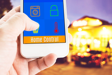 Poster - Hand holding smart phone with home control application with blur