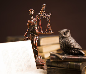 Golden scales of justice, books, Statue of Lady Justice. Owl and paragraph