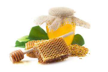 Wall Mural - A jar of honey, honeycomb with pollen.