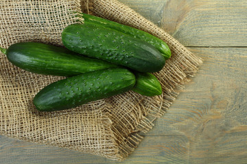 Wall Mural - Fresh cucumbers on a wooden background