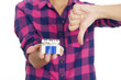 © Sunny - Young woman holding cigarettes and showing thumb down