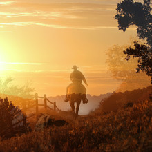 Sunset Cowboy.  A Cowboy Rides Off Into The Sunset In Transparent Layers Of Orange And Yellow Clouds, A Fence And Trees.