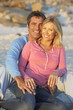 © Monkey Business - Portrait Of Couple Sitting On Beach