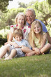 © Monkey Business - Grandparents And Grandchildren Sitting In Park Together
