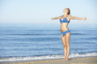 © Monkey Business - Young Woman Standing On Summer Beach