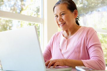 Senior Taiwanese woman working on laptop