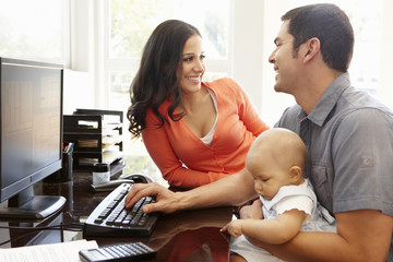 Wall Mural - Hispanic couple and baby in home office