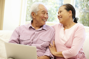 Wall Mural - Senior Asian couple using laptop