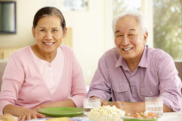 Wall Mural - Senior asian couple sharing meal at home